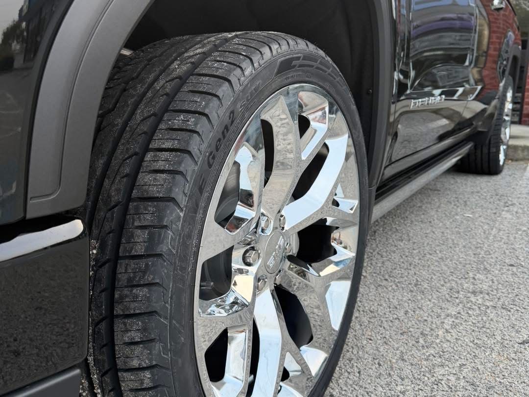 Close-up of a polished chrome wheel and tire fitted to a GMC pickup