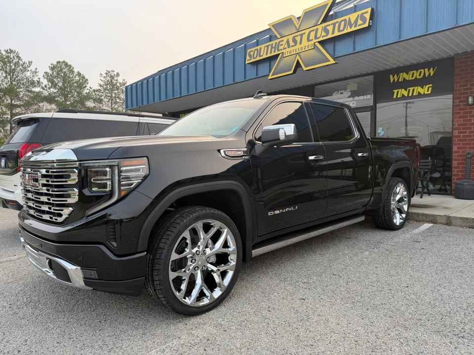 Black GMC Denali with polished wheels outside Southeast Customs