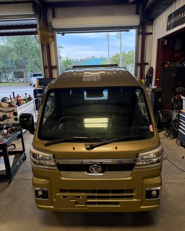 LED light bar mounted above the windshield of a compact truck